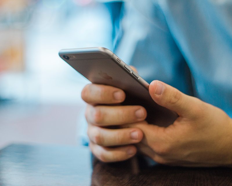 Man visiting a responsive website on his iPhone