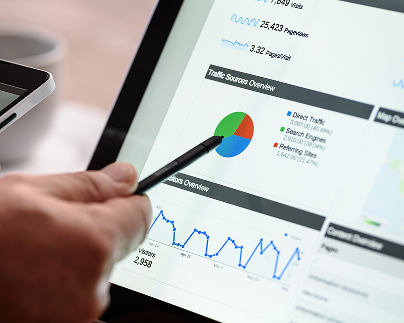 Person viewing website traffic analytics report on a tablet